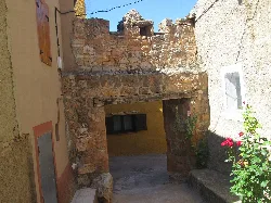 Stone gate with arch in the center of the image.