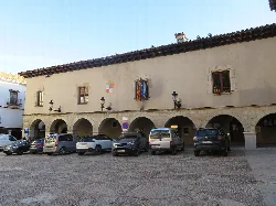 Plaza Mayor with arches and cars in Mosqueruela, Teruel.