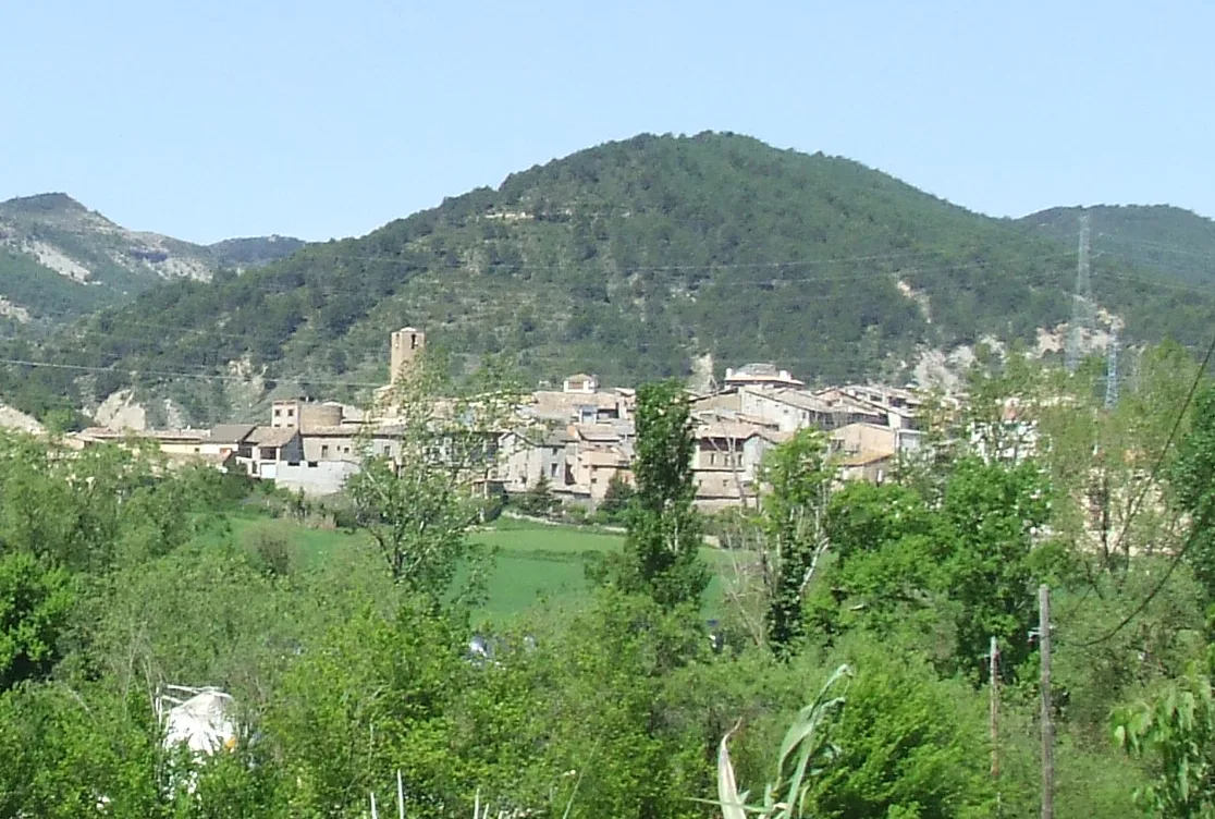 Town of Salàs de Pallars with houses and church in a mountain landscape.