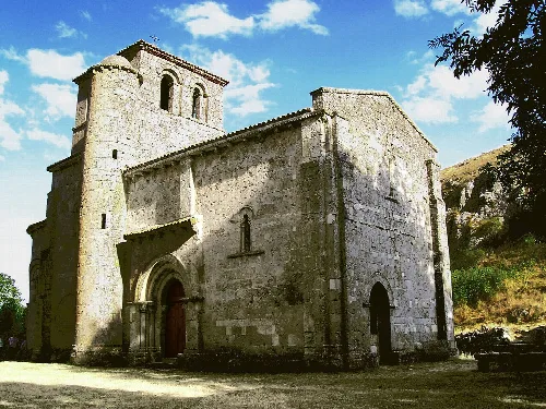 Stone facade and bell tower of the Romanic basilica at Monasterio de Rodilla.