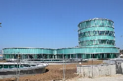 Modern building with circular shape and glass facade in Lalín.