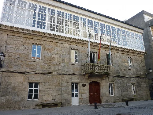 Rathaus von A Cañiza mit Steinfassade und großen Fenstern.