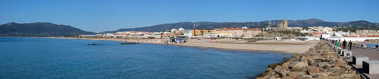 Panoramic view of Tarifa with sea, city, and mountains.