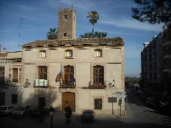 Building with tower and flags on the facade in Rocafort, Valencia.