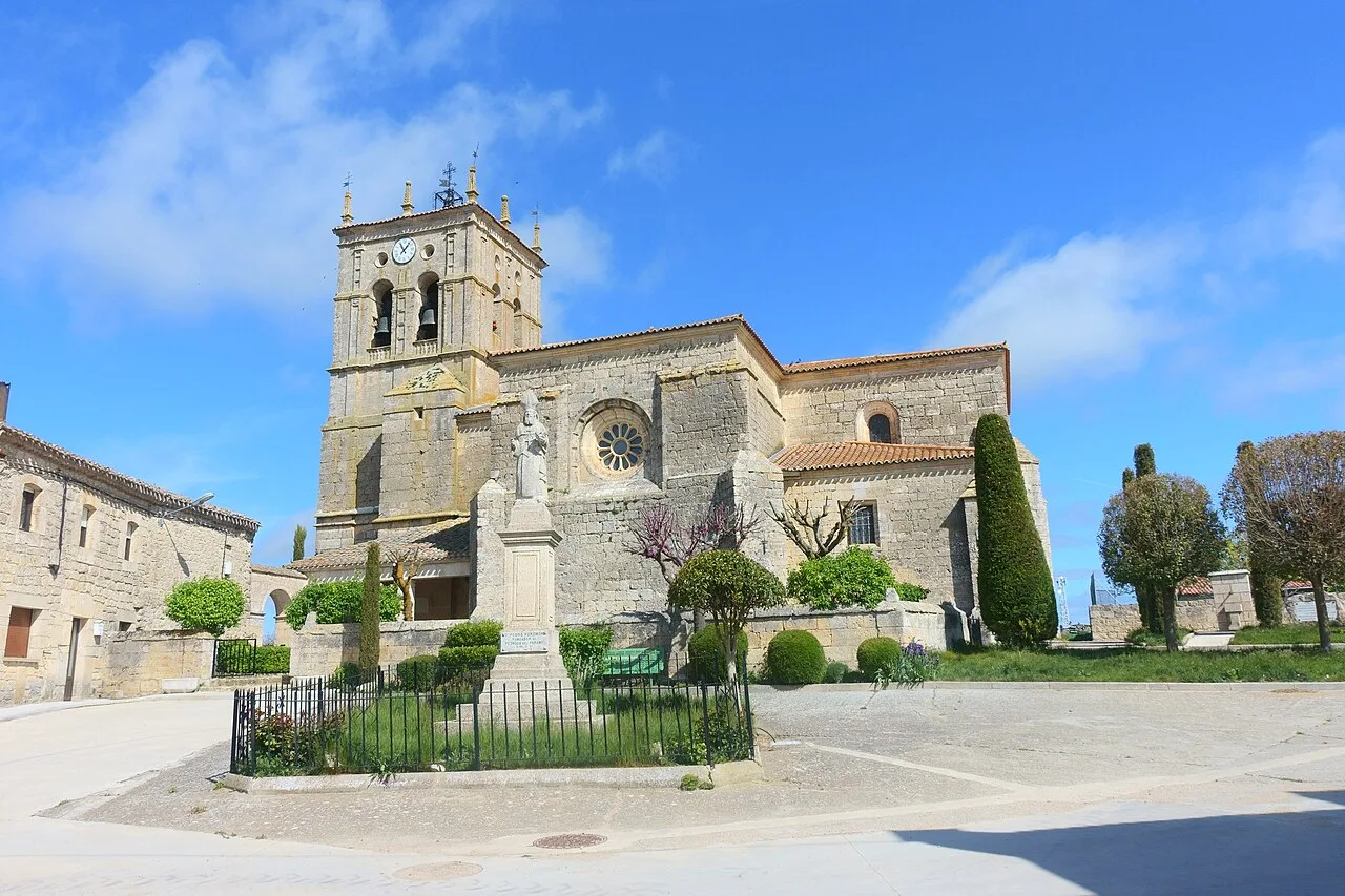 San Pedro Church in Pedrosa del Páramo with tower and trees.