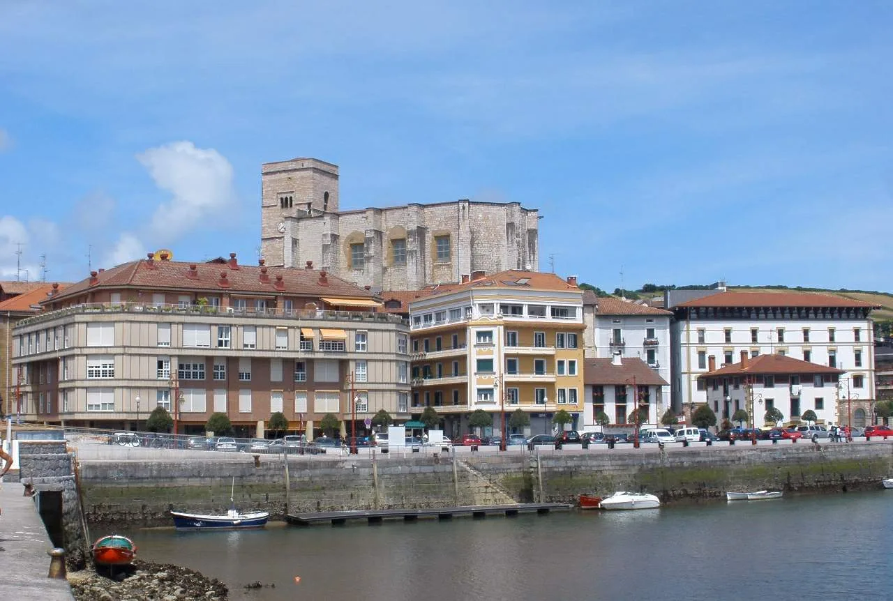 Buildings along the river and a church in Zumaia, Guipúzcoa.