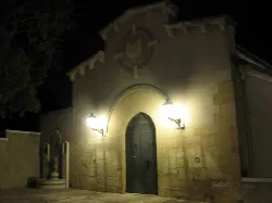 Blood Hermitage in Castalla, with door and street lamps lighting up the facade.
