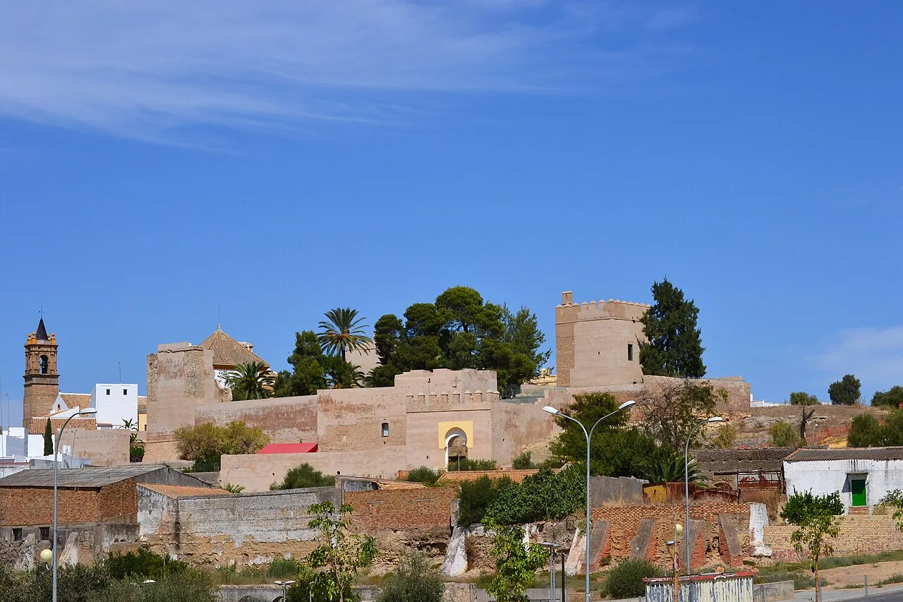 View of Luna Castle with stone walls and towers in Mairena del Alcor.