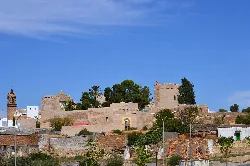 View of Luna Castle with stone walls and towers in Mairena del Alcor.