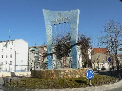 Modern sculpture with metal and stone structure at Azuqueca de Henares station.