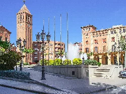 Square with fountain, street lamps, and historic buildings in Mollerusa.