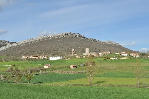 View of hills, houses, and a tower in Rebolledo de la Torre.