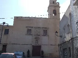 White facade with door, windows, tower, and decorative details of the convent.