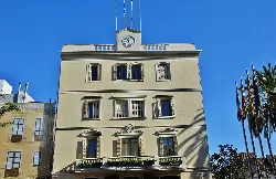 Building with clock and windows on the facade in San Baudilio de Llobregat.