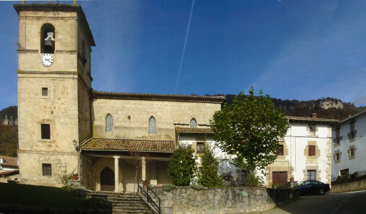 Stone church with tower and trees in Ameskoabarren, Navarra.