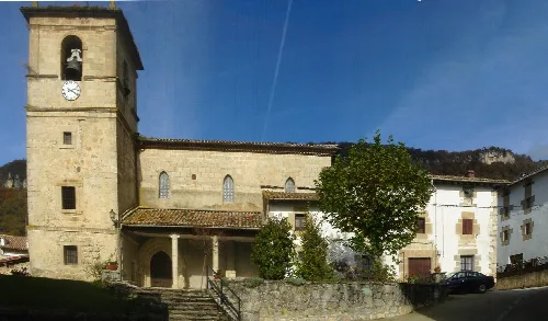 Steinernes Kirchengebäude mit Turm und Bäumen in Ameskoabarren, Navarra.