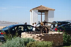 Cross of Cristo in the village El Cristo del Espiritu Santo with cars and shrine.