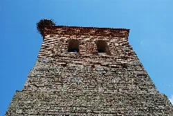 Stone tower with arched windows in Villasila de Valdavia.