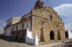Stone church facade with bell tower in Quel.