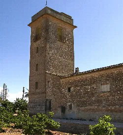 Stone tower with small windows in Guadassuar, Valencia.