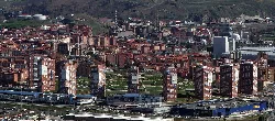 Aerial view of San Vicente Towers with city and mountains in the background.