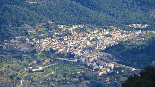 Aerial view of Bunyola with mountains and buildings.