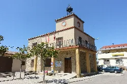 Town hall with clock and flags in Mombuey, Zamora.