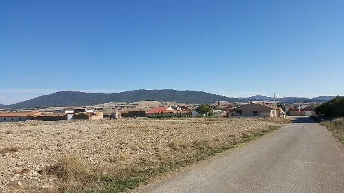 Rural landscape with village and mountains in the background