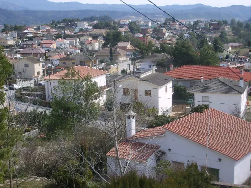 Weiße und bunte Häuser mit Ziegeldächern in Castellgalí, Barcelona.