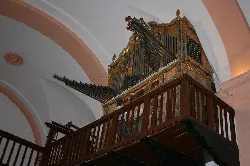 Old organ with gold details and wooden structure in Torre de Juan Abad church.