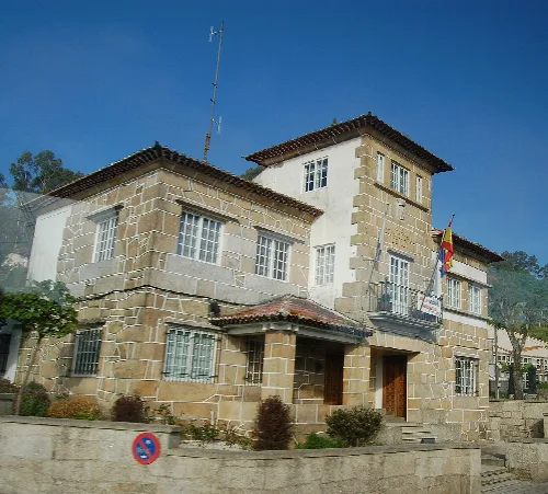 Town hall of Mos, stone building with tower and flag.