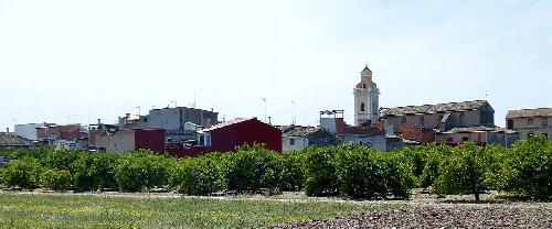 Landschaft mit Bäumen und Gebäuden in Alcàntera de Xúquer.
