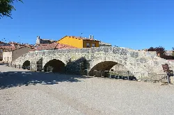 Stone bridge with three arches in Villangómez, Burgos.