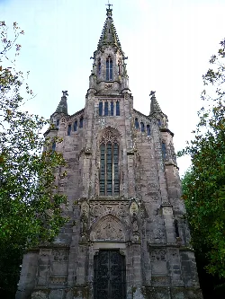 Front view of the chapel-mausoleum with Gothic details and a spire.