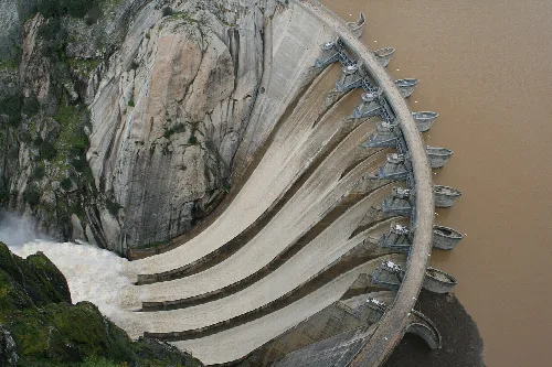 Aldeadávila Dam with multiple spillways in a rocky canyon.