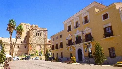 Plaza de España in Motril with yellow building and old tower.
