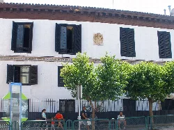 Building with wooden windows and street trees in Ricla, Zaragoza.