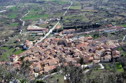 Aerial view of Poza de la Sal with houses and rural landscape.
