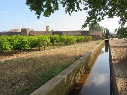 Walls and canal at the fortified complex of Mascarell in Nules.
