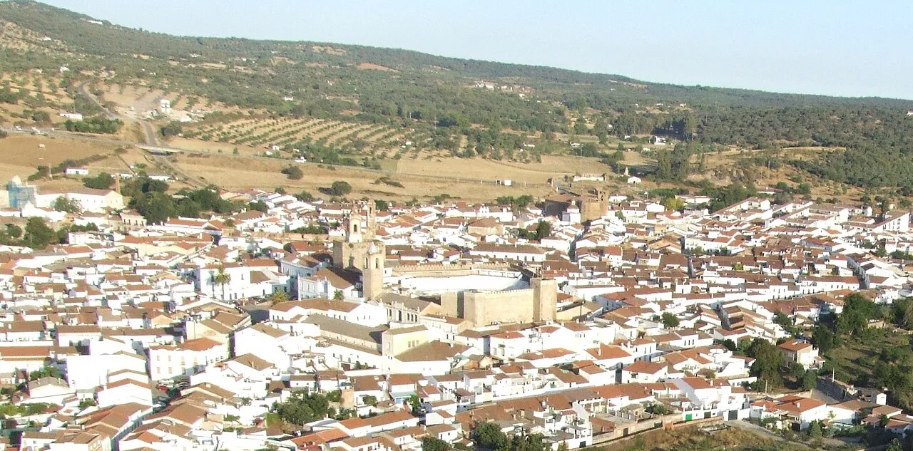 Vista aérea de un pueblo con tejados de tejas rojas y calles estrechas.