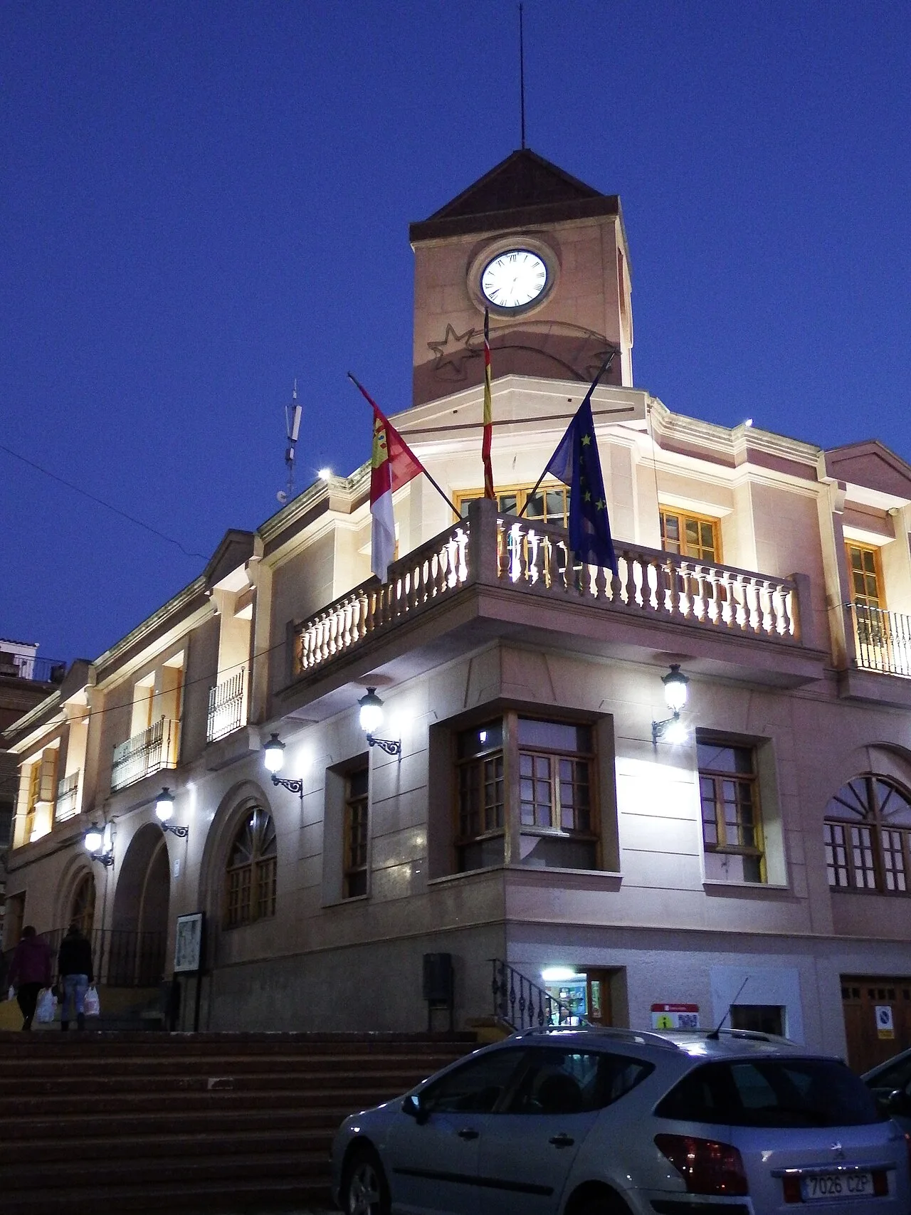Fuente-Álamo town hall with flags and a clock tower.