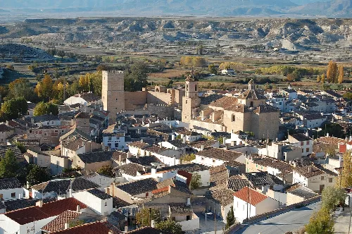 Panoramic view of Orce with church and houses in a mountainous landscape.