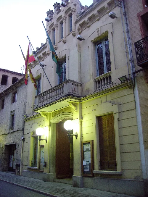 Rathaus von Canet de Mar mit Flaggen und Beleuchtung bei Nacht.