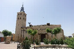 San Martín Obispo Church in Lillo with tower and stone facade.