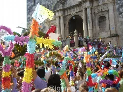 Crowd with colorful decorations at the San Gil festival in Enguera.