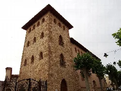 Torre de piedra con ventanas arqueadas y tejado de madera en Anna.