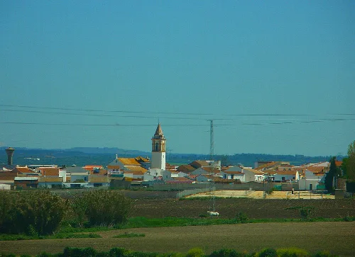 Rural landscape with church and houses in Villarrasa, Huelva.