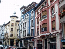 Colorful building facades with balconies and decorative details in Pravia.