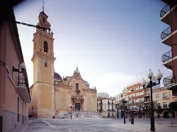 Church with baroque facade and tower in the main square of Benaguacil.