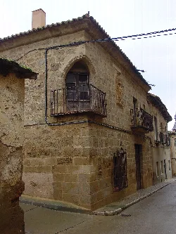Stone building with wrought iron balconies in Valderas, León.